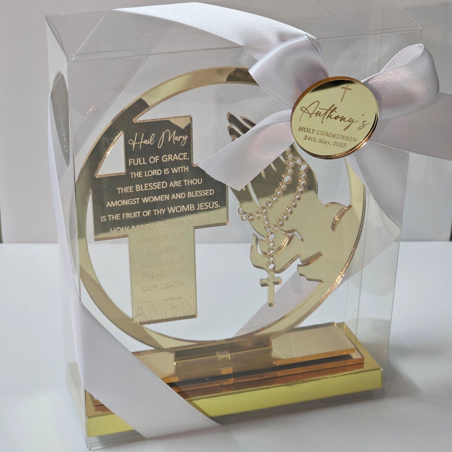 Acrylic Hail Mary prayer cross with rosary motif, displayed in a gift box with ribbon and personalised name tag.