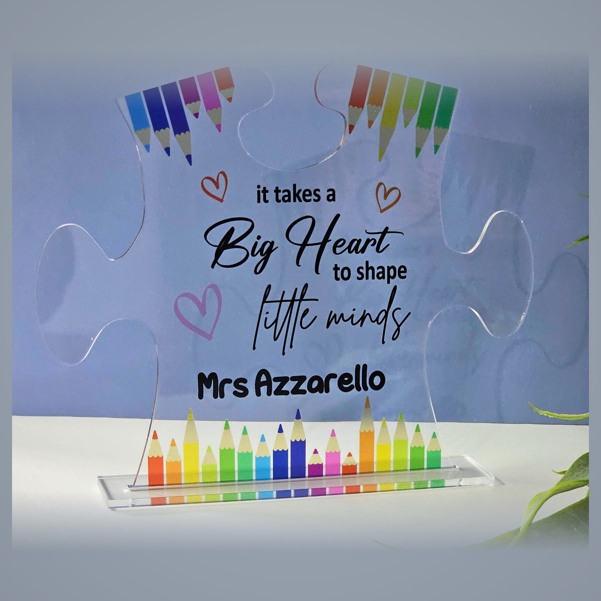 Clear acrylic puzzle piece teacher gift plaque with teacher name and colourful pencils