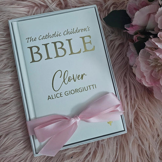 Personalised Catholic Children's Bible with a custom name cover, gold detailing, and a soft ribbon – perfect for baptisms, first communions, and christenings.