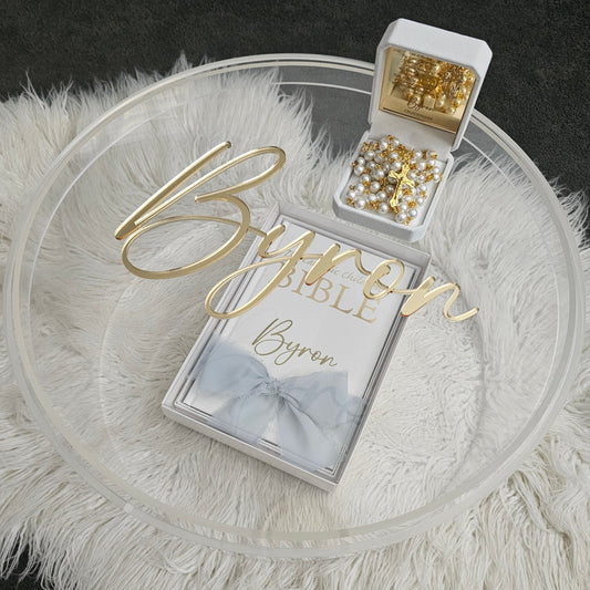 Luxury personalized gift set featuring a custom gold acrylic name plaque, personalized Bible, rosary beads, and a clear acrylic keepsake box – perfect for special occasions.