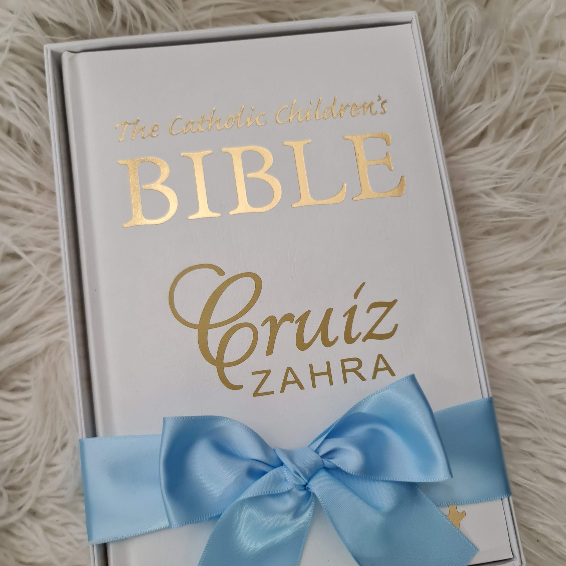 Personalised Catholic Children's Bible with a custom name cover, gold detailing, and a soft ribbon – perfect for baptisms, first communions, and christenings.