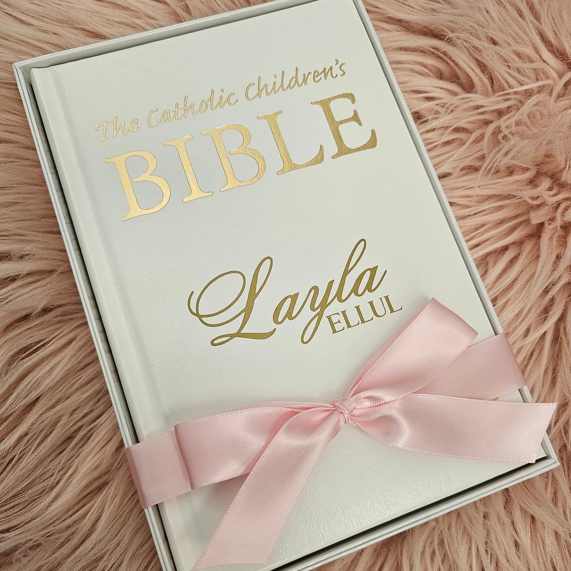Personalised Catholic Children's Bible with a custom name cover, gold detailing, and a soft ribbon – perfect for baptisms, first communions, and christenings.