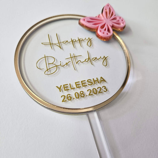 Elegant custom birthday cake topper with personalized name and date in a round design, featuring a delicate butterfly accent. Perfect for birthday celebrations.