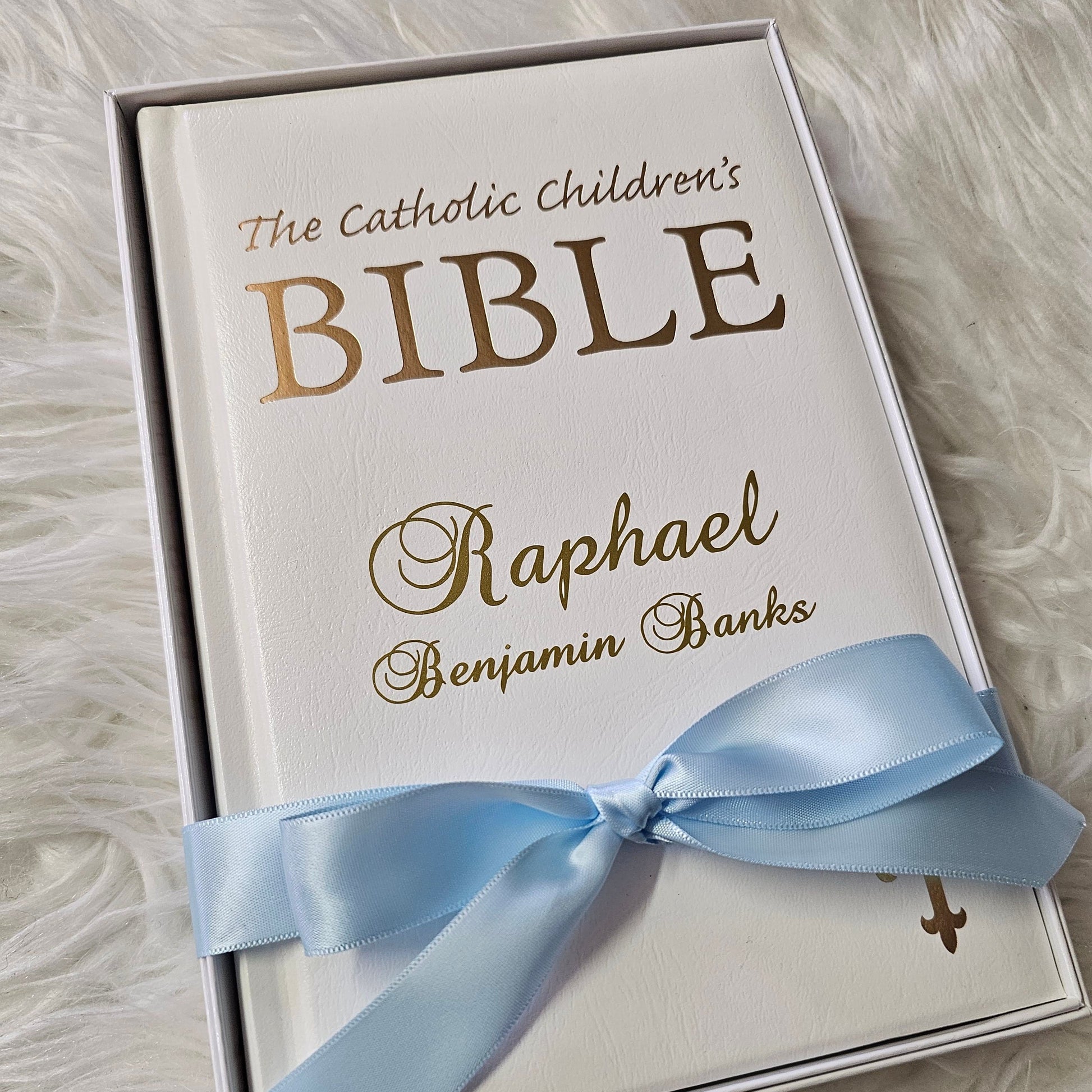 Personalised Catholic Children's Bible with a custom name cover, gold detailing, and a soft ribbon – perfect for baptisms, first communions, and christenings.