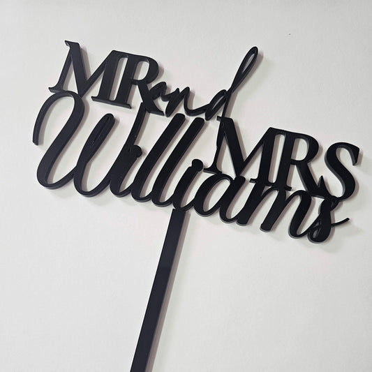 Custom  acrylic "Mr. & Mrs." wedding cake topper with a personalized last name, ideal for weddings, anniversaries, and engagement celebrations.