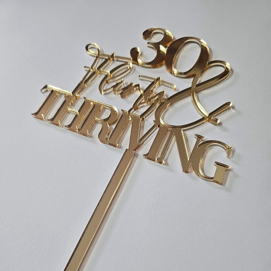 "30, Flirty & Thriving" cake topper, perfect for milestone birthday celebrations and glamorous 30th birthday parties.