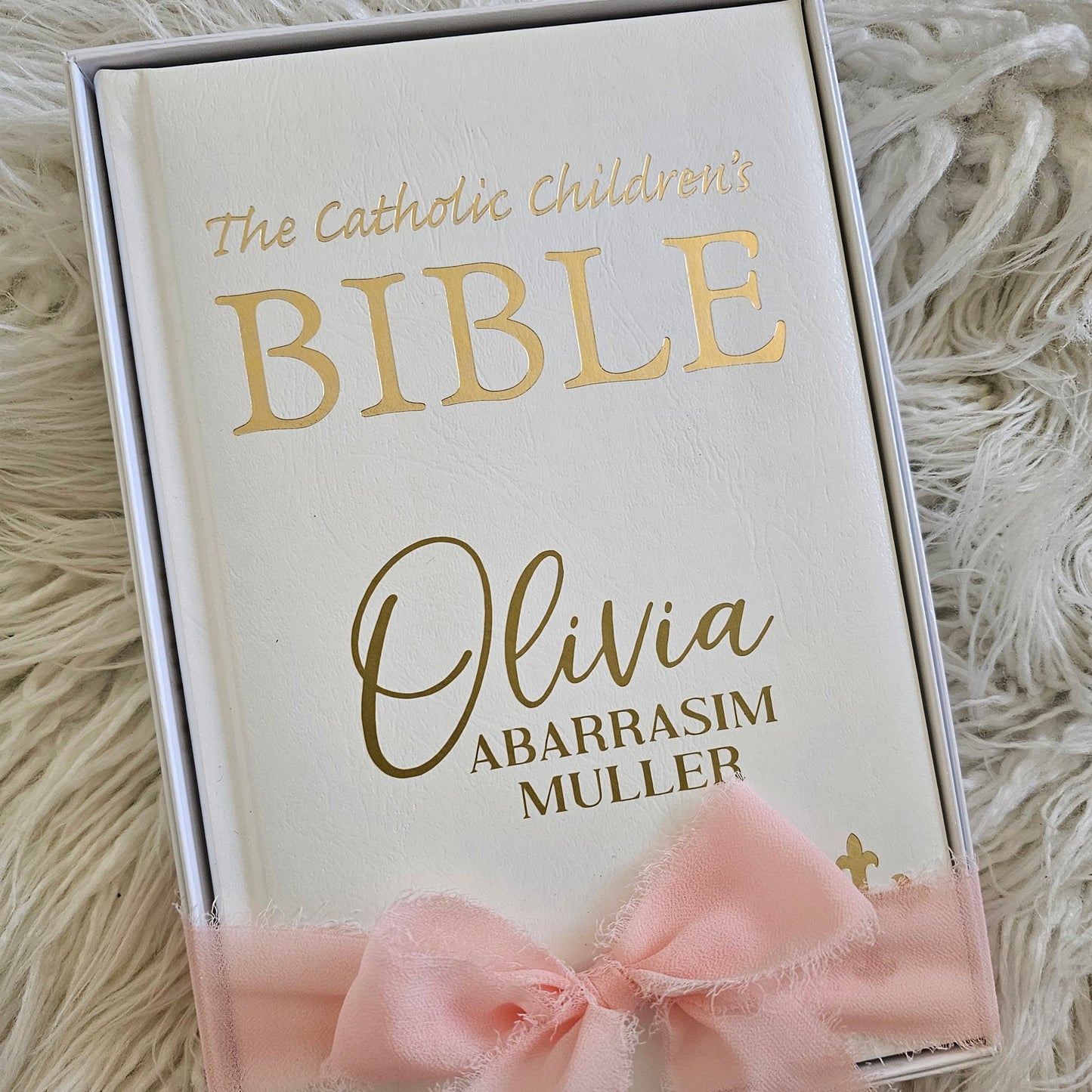 Personalised Catholic Children's Bible with a custom name cover, gold detailing, and a soft ribbon – perfect for baptisms, first communions, and christenings.