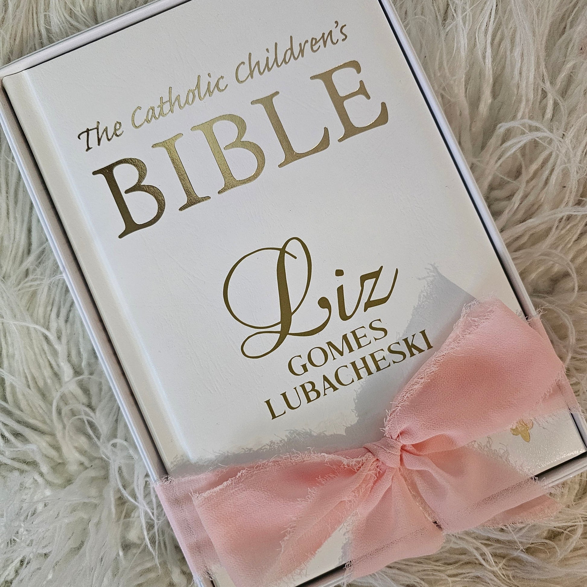Personalised Catholic Children's Bible with a custom name cover, gold detailing, and a soft ribbon – perfect for baptisms, first communions, and christenings.