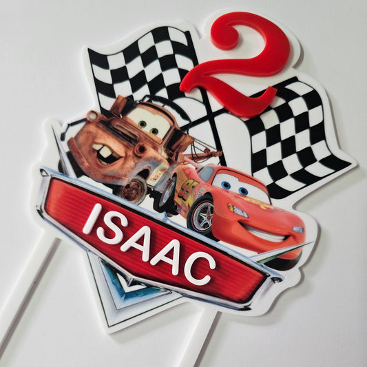 Personalized racing-themed cake topper with checkered flags, a number, and a custom nameplate.