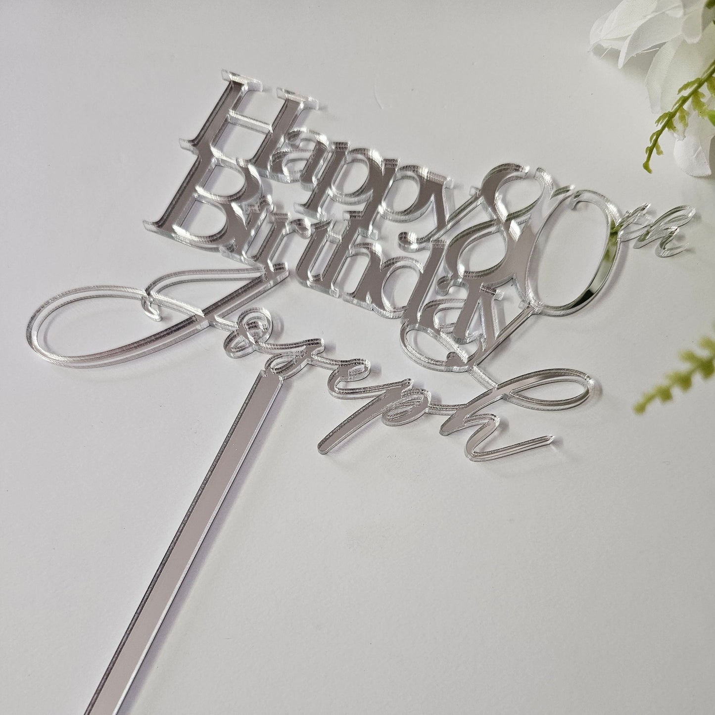 Elegant personalized milestone birthday cake topper with a custom name and age in a stylish script design.