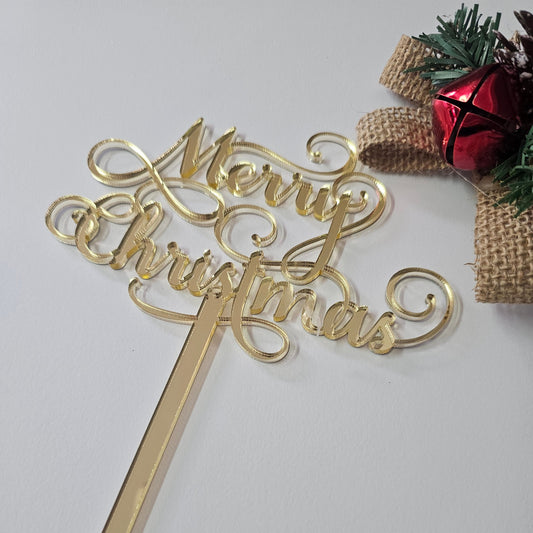 Gold "Merry Christmas" cake topper with an elegant script design, perfect for holiday celebrations.