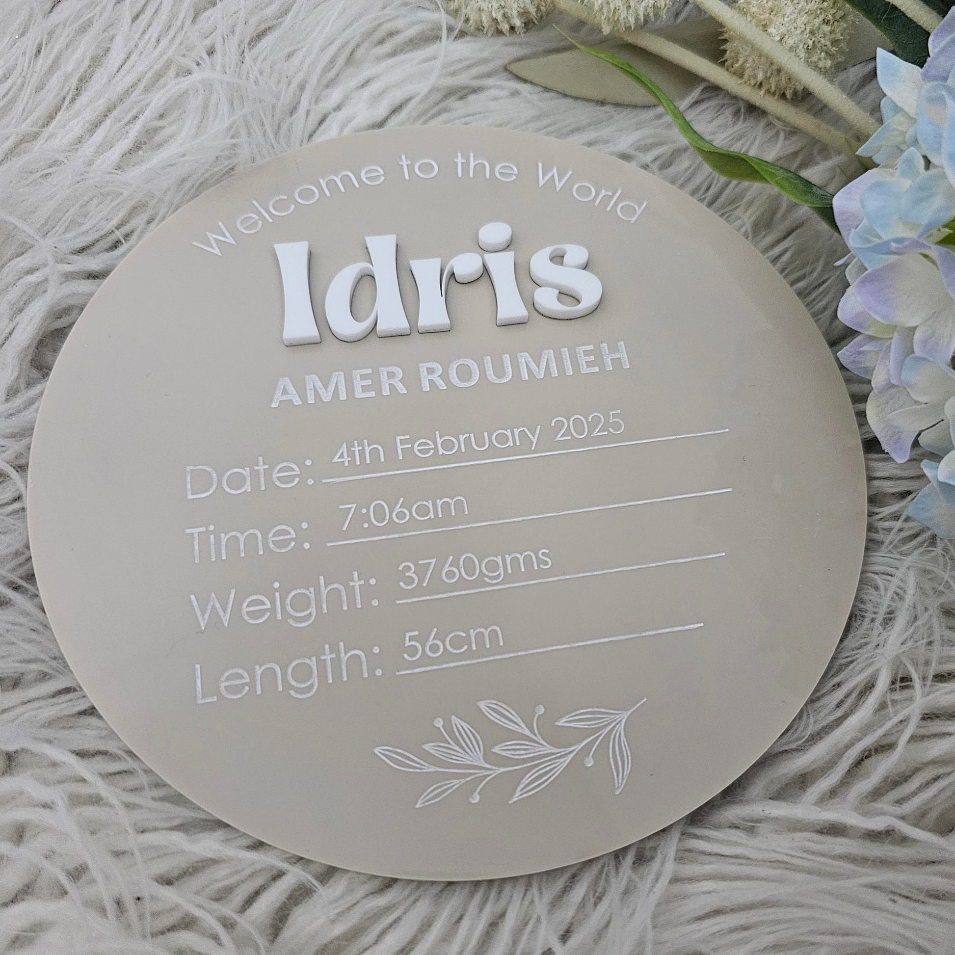 Acrylic birth announcement plaque with raised 3D script first name and UV printed full name and birth details in serif and script fonts.