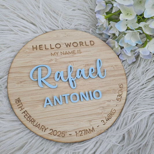 Engraved bamboo baby plaque with “Hello World” and personalised birth details including name, date, time, weight, and length.