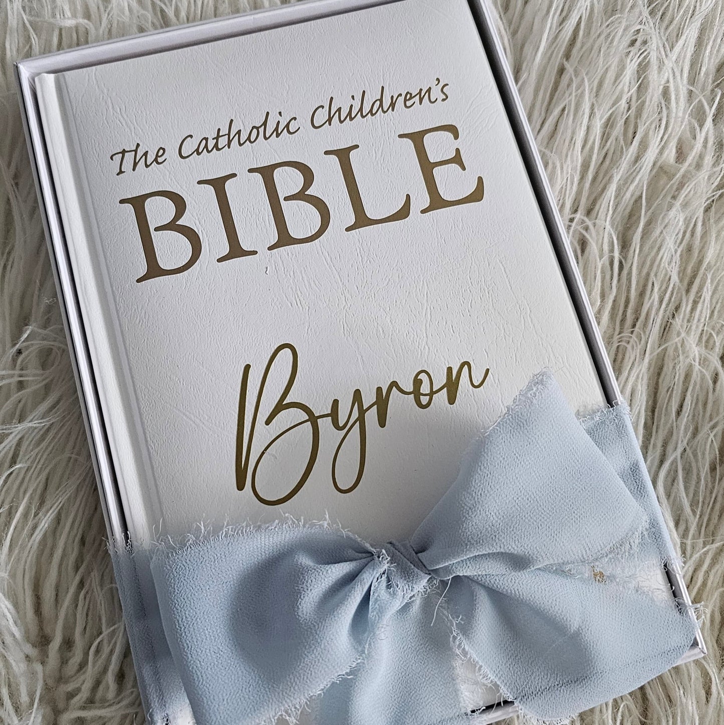 Personalised Catholic Children's Bible with a custom name cover, gold detailing, and a soft ribbon – perfect for baptisms, first communions, and christenings.