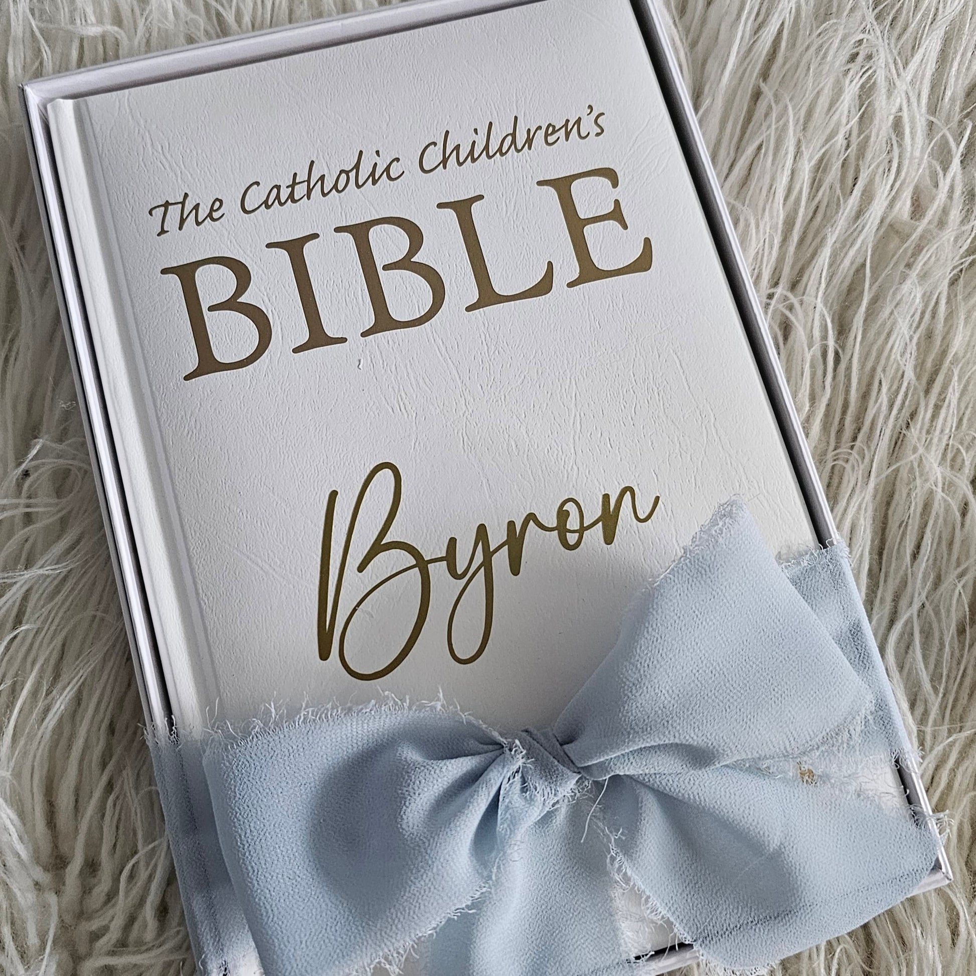 Personalised Catholic Children's Bible with a custom name cover, gold detailing, and a soft ribbon – perfect for baptisms, first communions, and christenings.