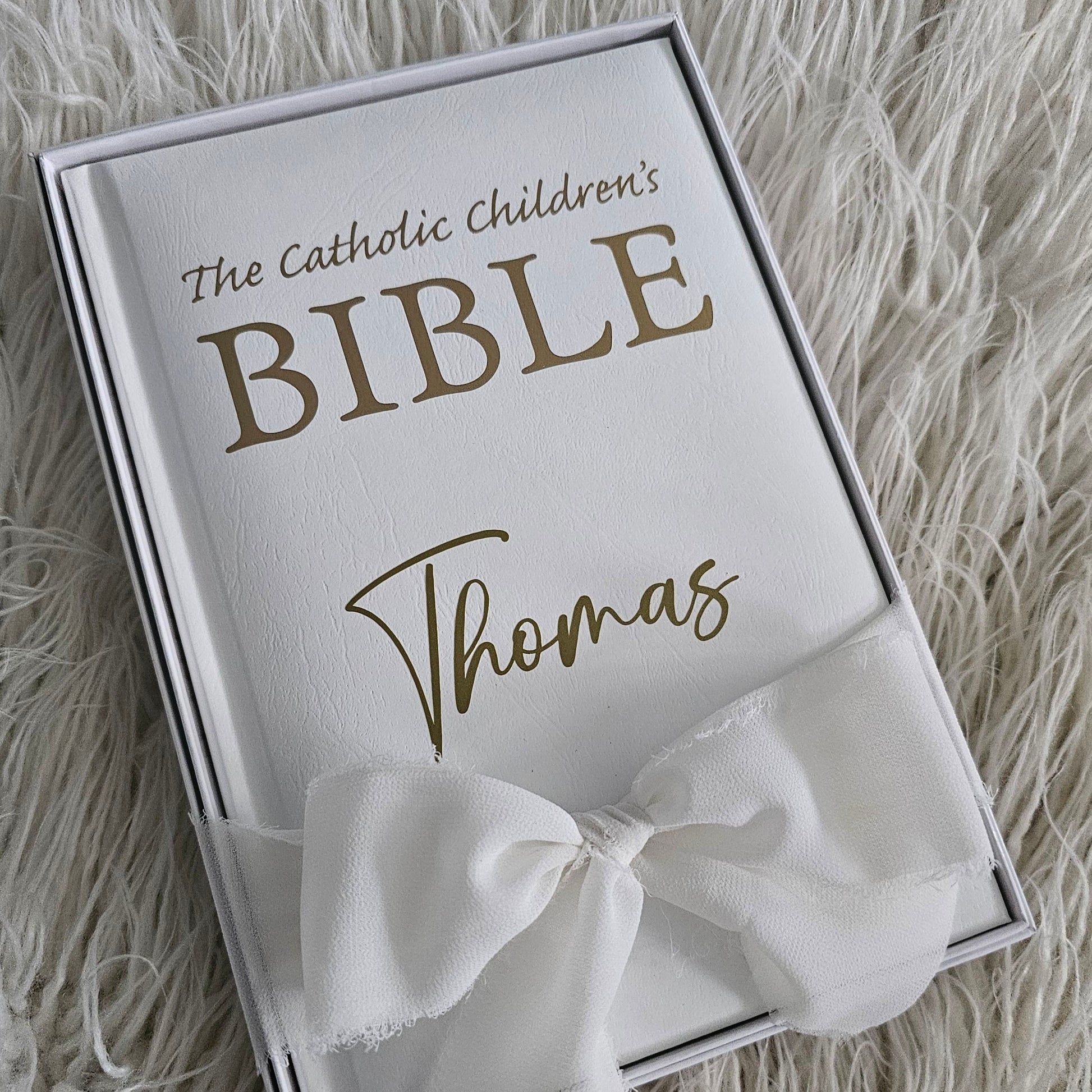 Personalised Catholic Children's Bible with a custom name cover, gold detailing, and a soft ribbon – perfect for baptisms, first communions, and christenings.