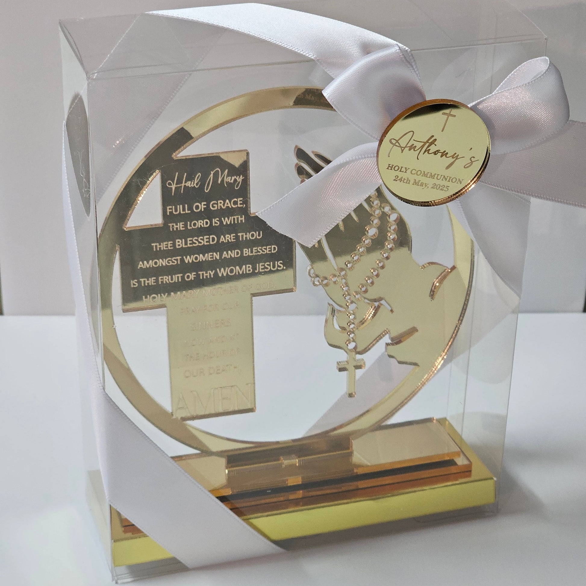 Acrylic Hail Mary prayer cross with rosary motif, displayed in a gift box with ribbon and personalised name tag.