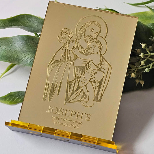 Gold mirror acrylic Communion bonbonniere with engraved saint figure, floral elements, and personalised name and date.