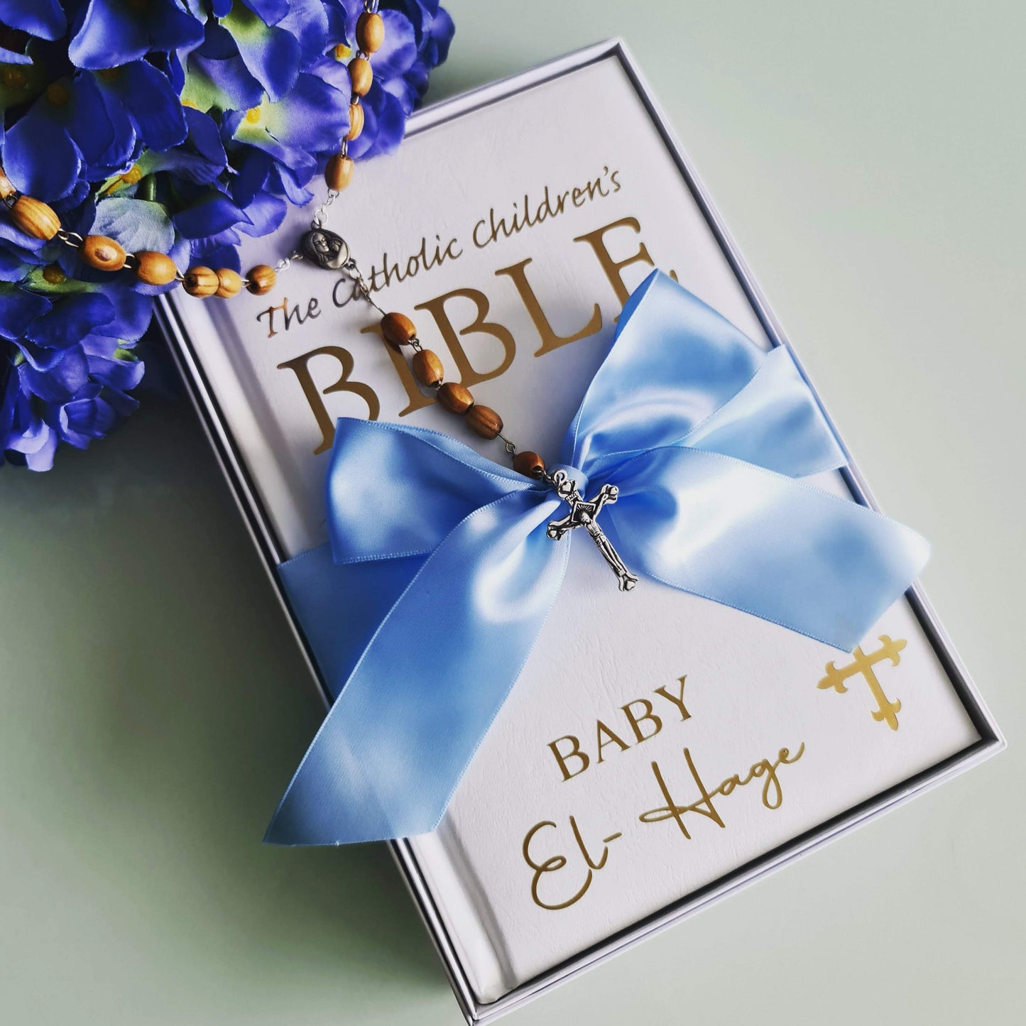 Personalised Catholic Children's Bible with a custom name cover, gold detailing, and a soft ribbon – perfect for baptisms, first communions, and christenings.