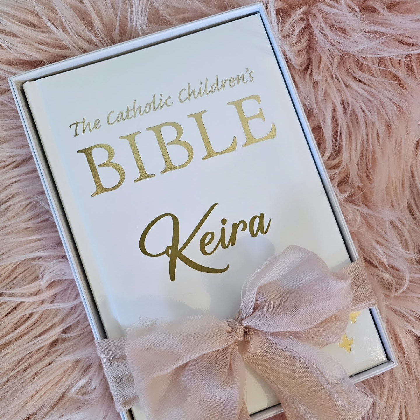 Personalised Catholic Children's Bible with a custom name cover, gold detailing, and a soft ribbon – perfect for baptisms, first communions, and christenings.