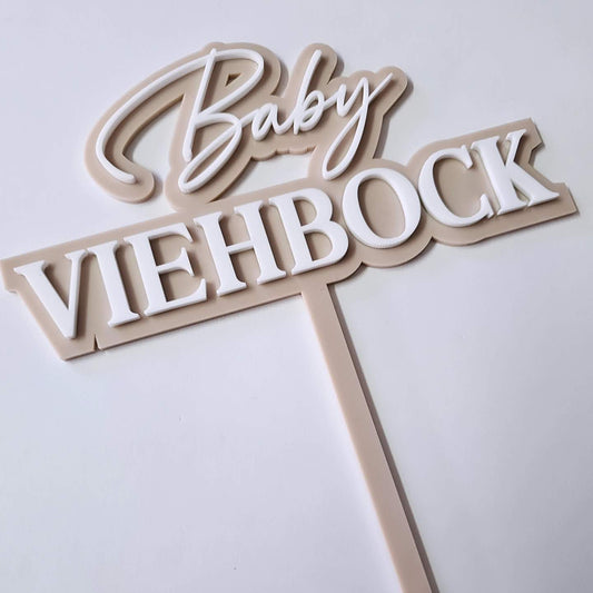 Custom baby name double-layer acrylic cake topper in beige and white, featuring script and bold block lettering, perfect for baby showers and gender reveal parties.