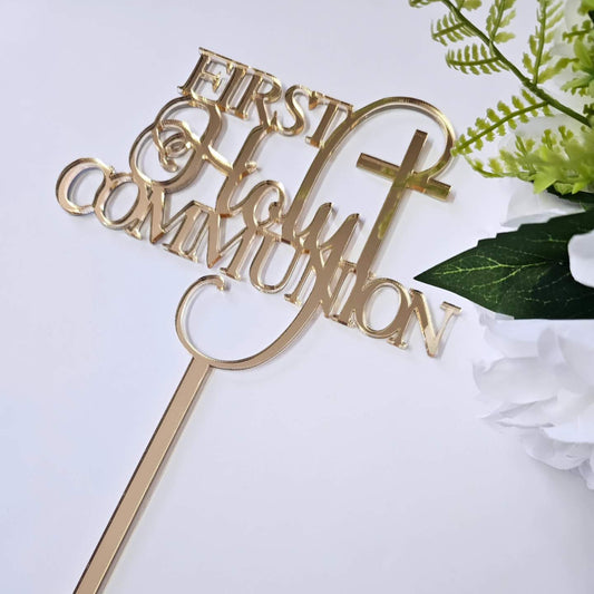 Gold acrylic First Holy Communion cake topper with elegant script font and cross detail.