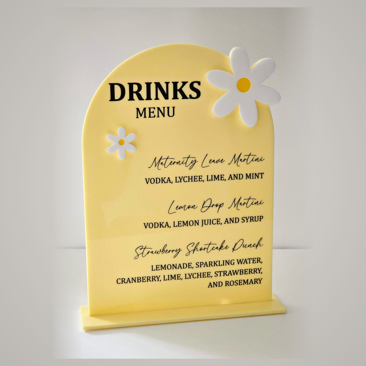 Yellow arched acrylic drinks menu sign with daisies - custom bar menu for party