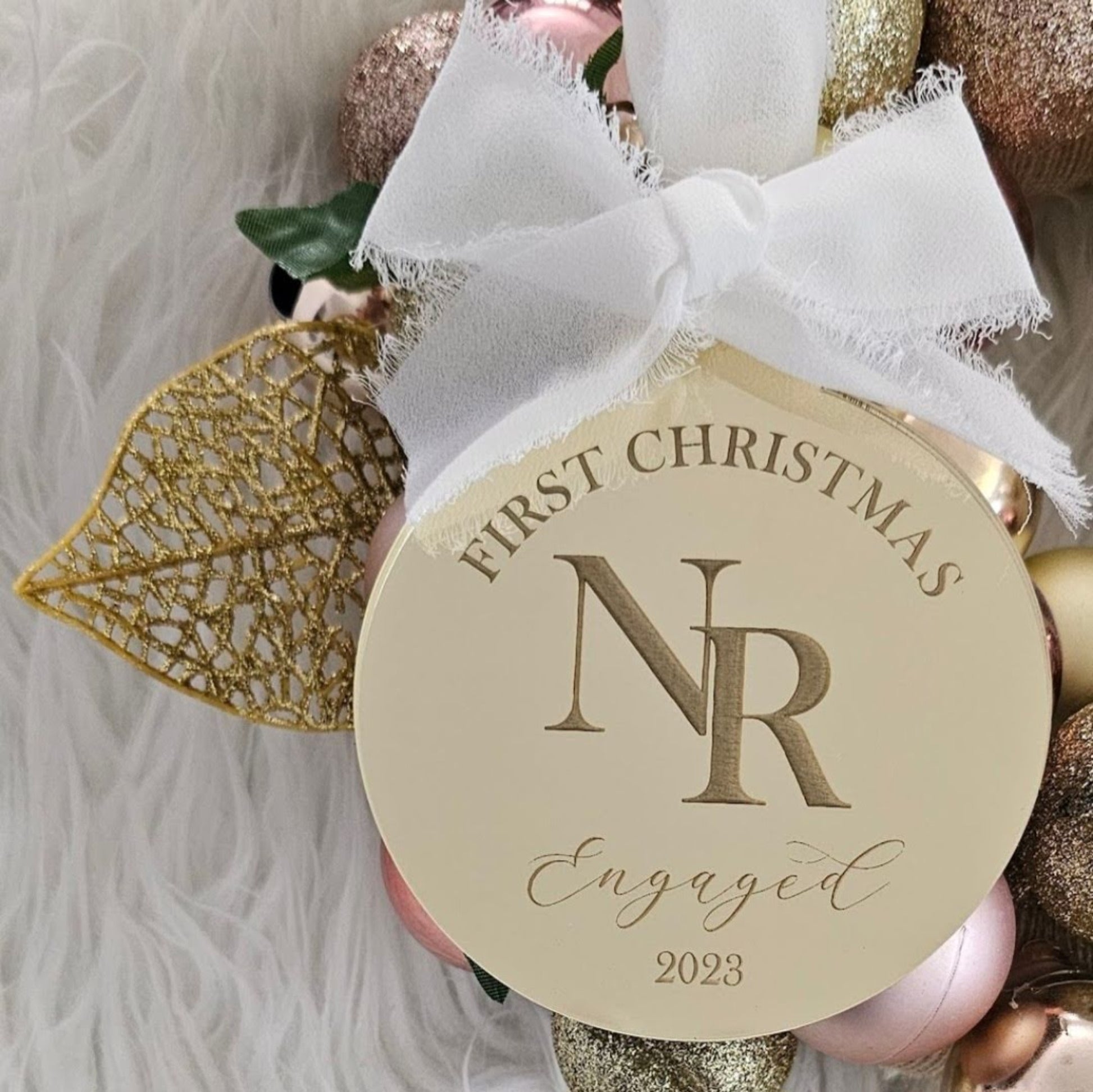 Gold acrylic “First Christmas Engaged” ornament with white ribbon bow — personalised holiday keepsake for engaged couples handmade in Australia