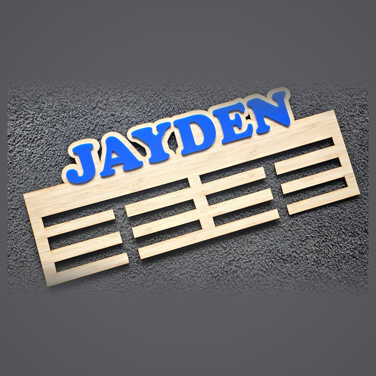 Personalised timber medal hanger with raised blue acrylic name - custom sports medal display
