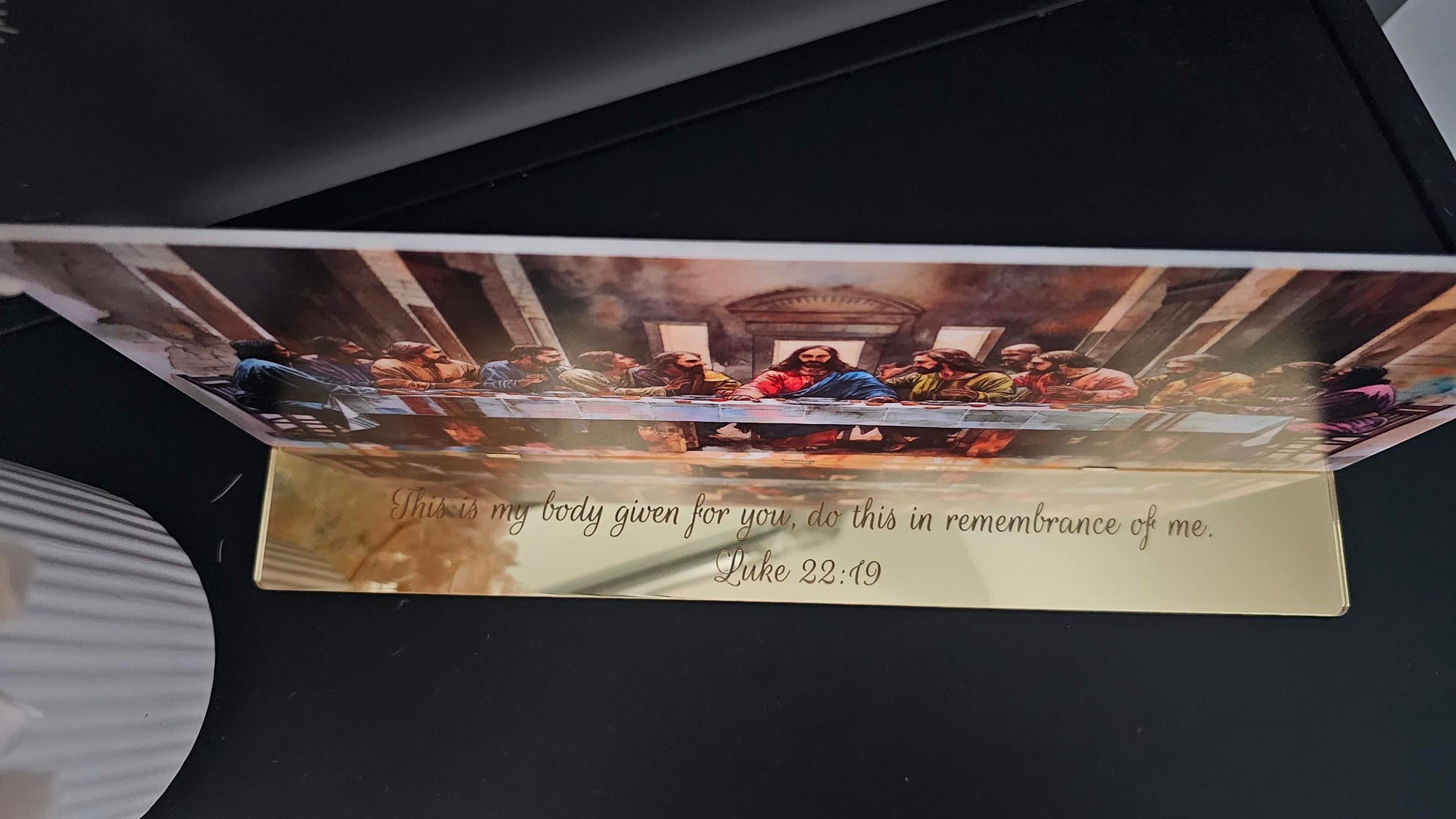 Close-up side view of The Last Supper acrylic artwork showing engraved Luke 22:19 scripture on mirror-gold base — handmade religious gift piece