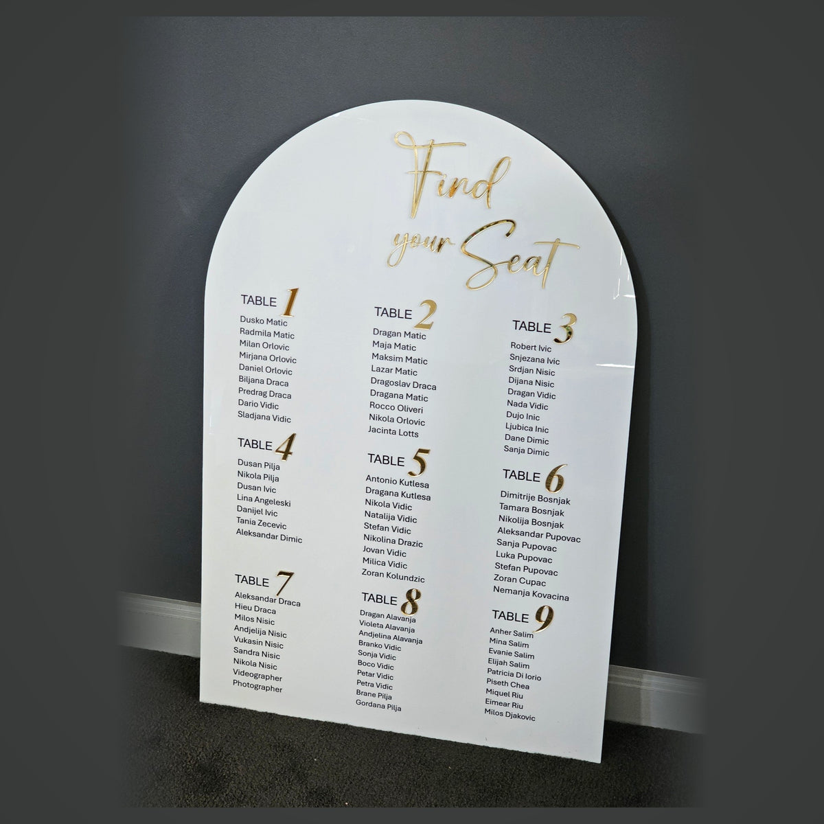 White arched acrylic Find Your Seat wedding seating chart with table lists - custom event signage